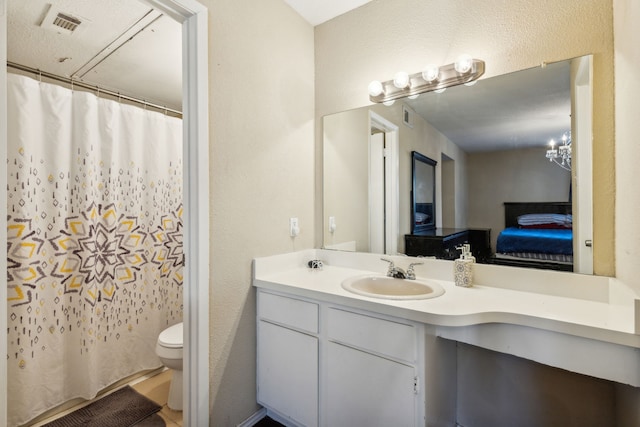 full bath featuring ensuite bathroom, visible vents, toilet, and vanity
