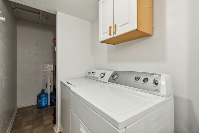 laundry room with cabinet space, baseboards, washer and clothes dryer, and dark floors