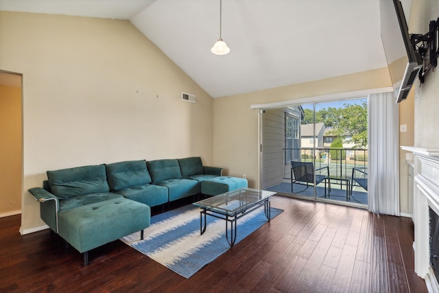 living room featuring visible vents, a fireplace, wood finished floors, high vaulted ceiling, and baseboards