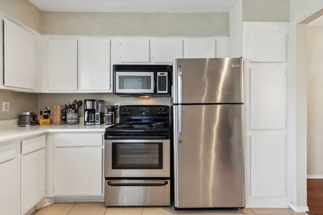 kitchen with light countertops, white cabinets, and stainless steel appliances