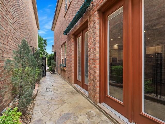 view of home's exterior with a patio area and brick siding