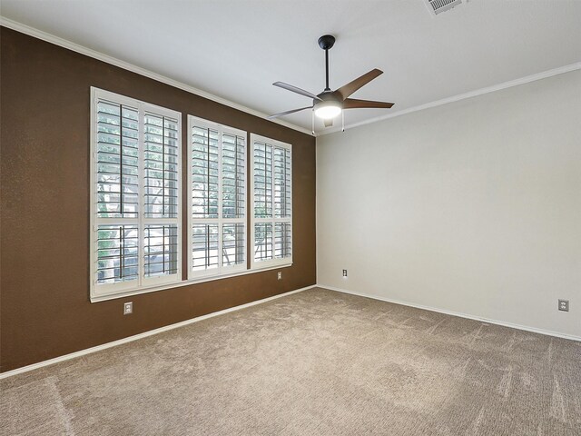 unfurnished room featuring crown molding, ceiling fan, carpet floors, and baseboards