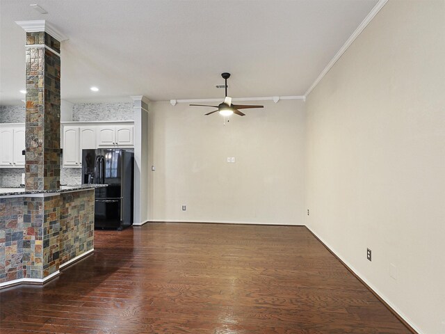 unfurnished living room with crown molding, a ceiling fan, decorative columns, and dark wood finished floors
