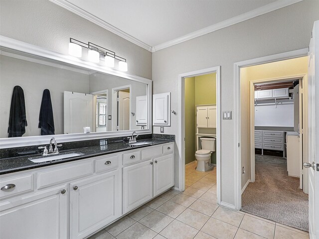 full bath featuring tile patterned flooring, a sink, crown molding, and double vanity