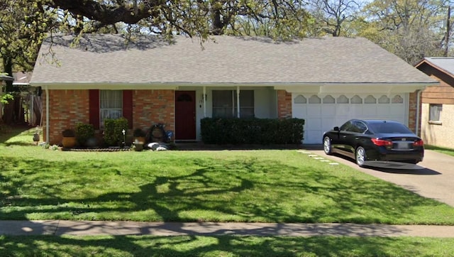 ranch-style home with brick siding, an attached garage, and a front yard