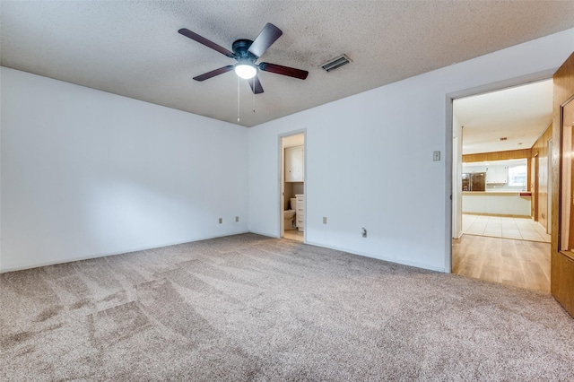 1515 Senter Rd, Irving, TX 75060 - unfurnished bedroom featuring ceiling fan, carpet floors, a textured ceiling, ensuite bathroom, and visible vents