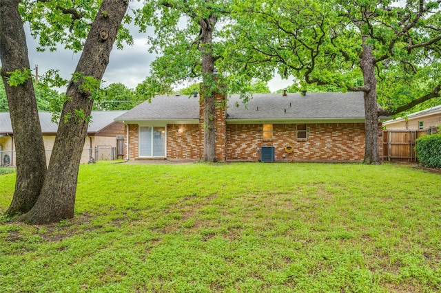 1515 Senter Rd, Irving, TX 75060 - back of house featuring a lawn, brick siding, fence, and roof with shingles