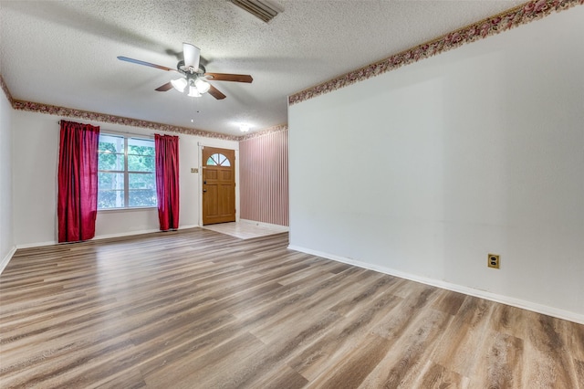 1515 Senter Rd, Irving, TX 75060 - interior space featuring visible vents, a ceiling fan, a textured ceiling, and wood finished floors