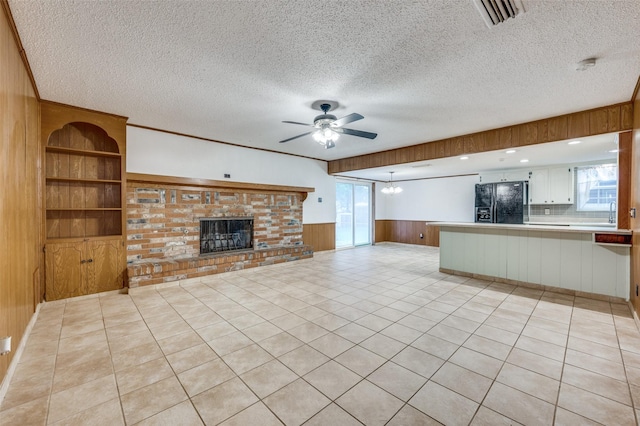 1515 Senter Rd, Irving, TX 75060 - unfurnished living room featuring visible vents, a textured ceiling, ceiling fan, and wainscoting