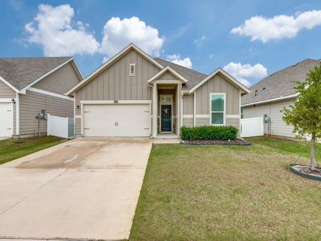 view of front of home featuring board and batten siding, fence, a front lawn, concrete driveway, and an attached garage
