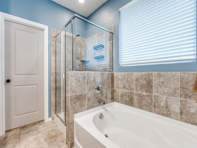 bathroom with a garden tub and a shower stall