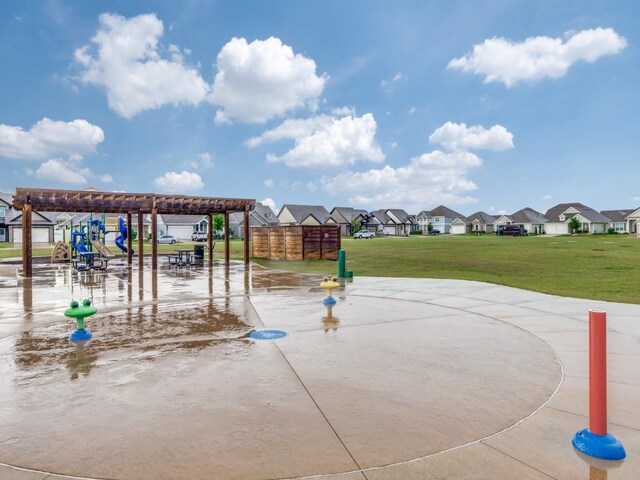 view of playground with a lawn and a residential view