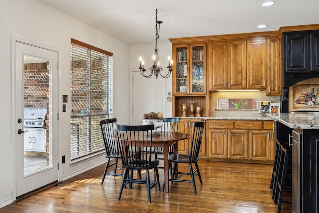 dining area with recessed lighting, a chandelier, and wood finished floors