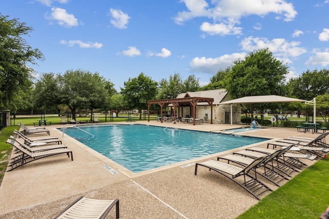 pool with a patio and a pergola