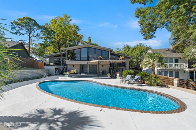 pool featuring fence and a patio area