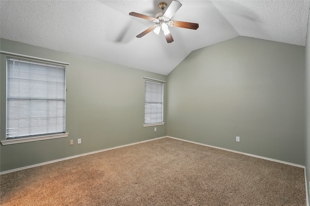 carpeted empty room with baseboards, ceiling fan, a textured ceiling, and lofted ceiling