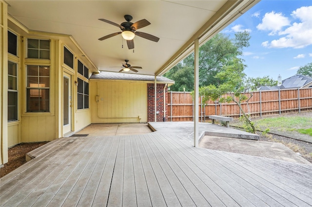 wooden deck featuring ceiling fan and fence