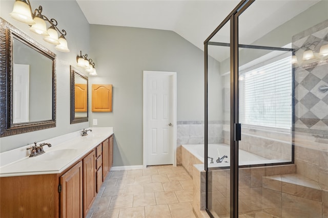 bathroom featuring a sink, double vanity, lofted ceiling, a garden tub, and a stall shower