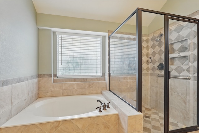 bathroom with a shower stall and a garden tub
