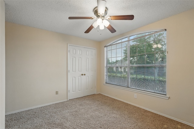 unfurnished bedroom with baseboards, carpet, and a closet