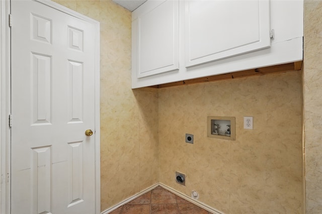 washroom featuring baseboards, hookup for an electric dryer, cabinet space, and hookup for a washing machine