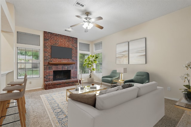 carpeted living room with baseboards, a fireplace, and visible vents