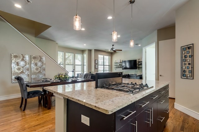 kitchen featuring ceiling fan, stainless steel gas cooktop, recessed lighting, baseboards, and light wood-type flooring