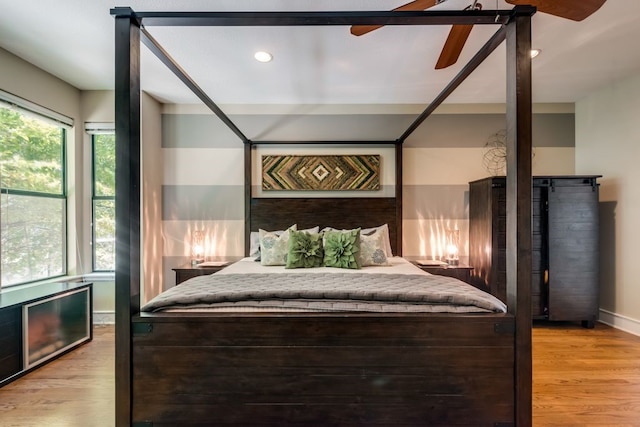 bedroom with light wood-style floors, baseboards, a ceiling fan, and recessed lighting