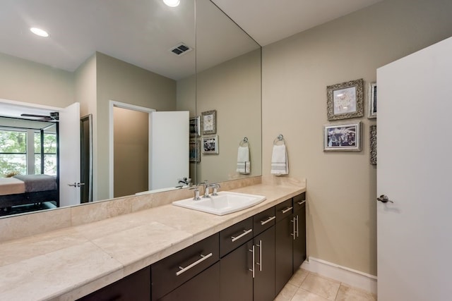 ensuite bathroom featuring ensuite bath, vanity, tile patterned floors, baseboards, and visible vents
