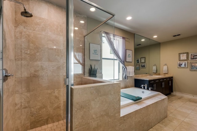 bathroom featuring visible vents, a bath, and a shower stall