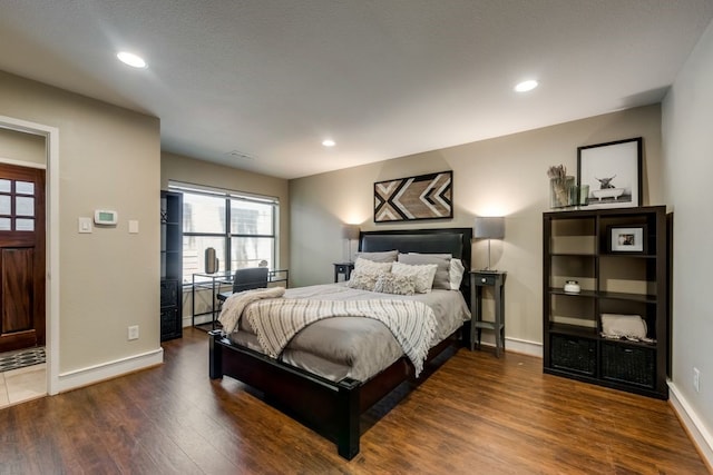 bedroom with recessed lighting, baseboards, and wood finished floors
