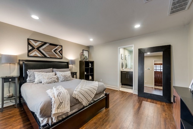 bedroom with baseboards, dark wood-type flooring, recessed lighting, and visible vents