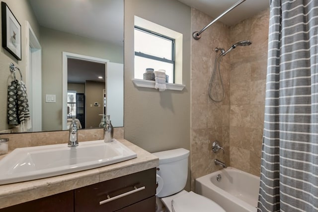 full bathroom with vanity, shower / bathtub combination with curtain, and toilet