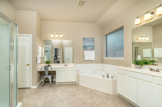 full bath featuring a sink, two vanities, a bath, and visible vents