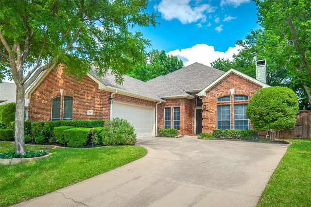 single story home featuring a shingled roof, brick siding, a garage, a chimney, and concrete driveway