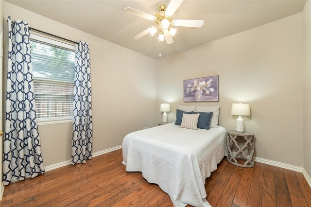 bedroom featuring baseboards, ceiling fan, and hardwood / wood-style flooring