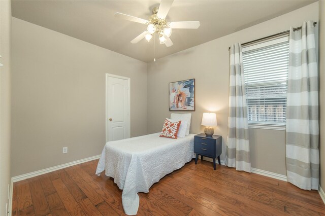 bedroom featuring baseboards, a ceiling fan, and wood finished floors