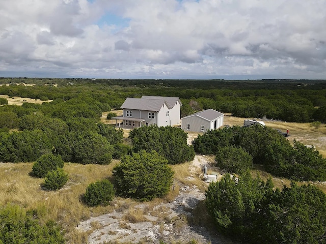 bird's eye view featuring a wooded view
