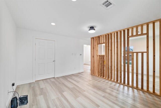 unfurnished room featuring visible vents, recessed lighting, baseboards, and wood finished floors