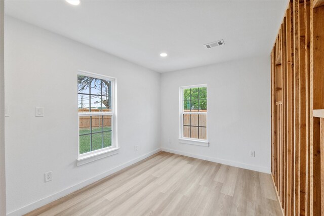 empty room with visible vents, recessed lighting, light wood finished floors, and baseboards