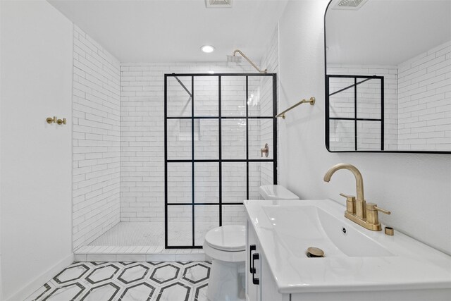 full bathroom featuring toilet, walk in shower, visible vents, and vanity