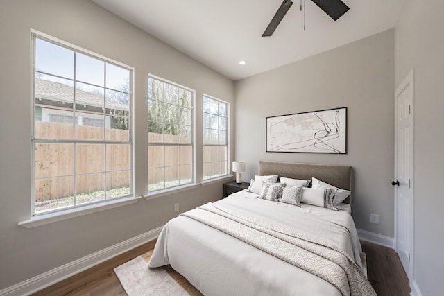 bedroom with baseboards, recessed lighting, ceiling fan, and wood finished floors