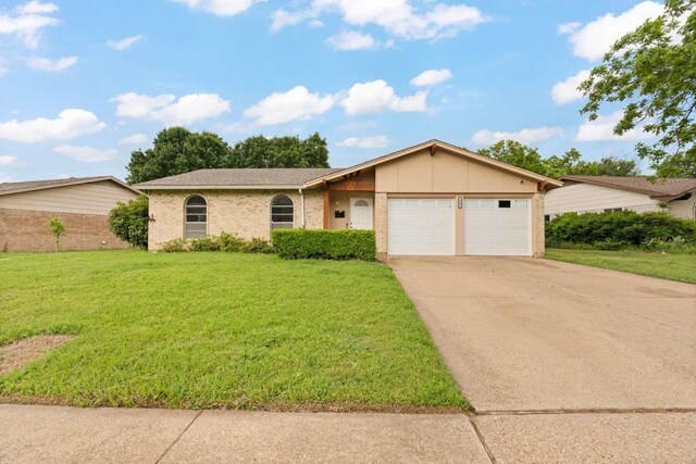 single story home featuring an attached garage, concrete driveway, a front lawn, and brick siding