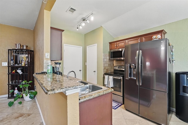 3145 Ronay Dr, Forest Hill, TX 76140 - kitchen featuring a peninsula, visible vents, appliances with stainless steel finishes, decorative backsplash, and light stone counters