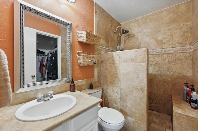3145 Ronay Dr, Forest Hill, TX 76140 - bathroom featuring walk in shower, toilet, vanity, and a textured ceiling