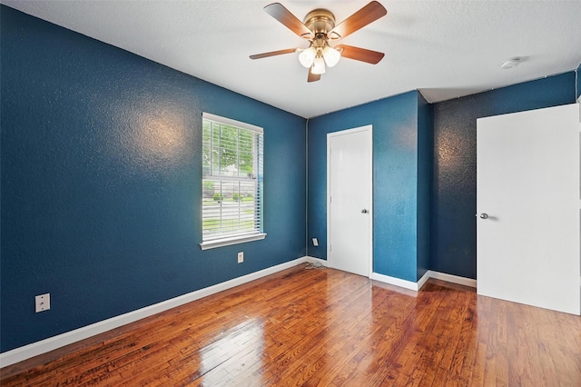 3145 Ronay Dr, Forest Hill, TX 76140 - unfurnished bedroom with a textured wall, baseboards, and wood finished floors