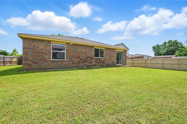 3145 Ronay Dr, Forest Hill, TX 76140 - back of property with brick siding, a lawn, and a fenced backyard