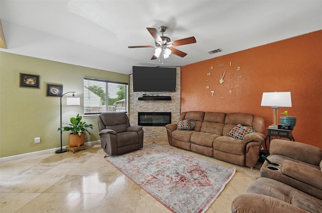 3145 Ronay Dr, Forest Hill, TX 76140 - living room featuring visible vents, ceiling fan, a textured wall, baseboards, and a stone fireplace