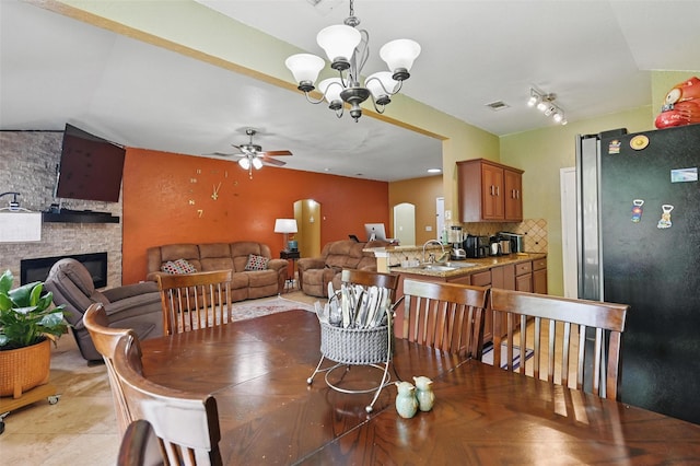 3145 Ronay Dr, Forest Hill, TX 76140 - dining area featuring visible vents, a fireplace, and ceiling fan with notable chandelier