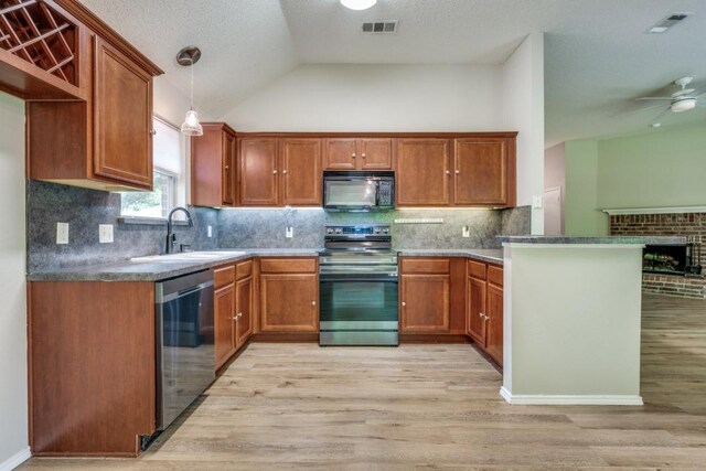 kitchen with a sink, appliances with stainless steel finishes, light wood finished floors, and visible vents